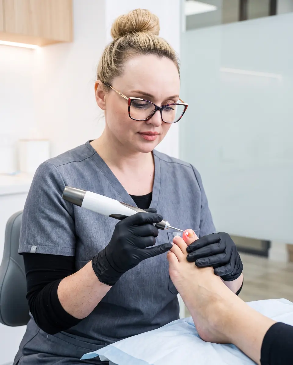 Sarah-Jane Walls providing medical laser treatment during a podiatry appointment at The Hub Glasgow
